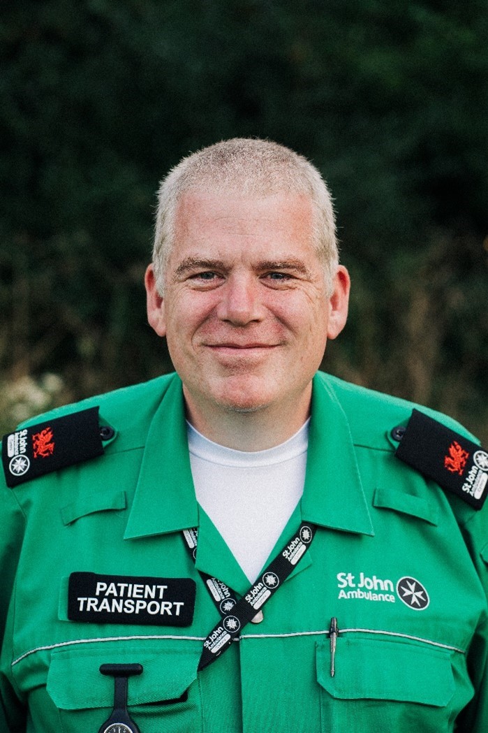 St John Ambulance Cymru Volunteer Dave High wearing his green St John Ambulance uniform with pride 